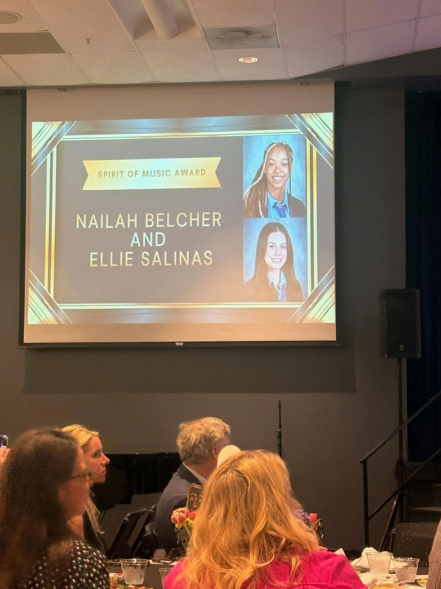 Presentation slide recognizing Nailah Belcher with the Spirit of Music Award alongside Ellie Salinas