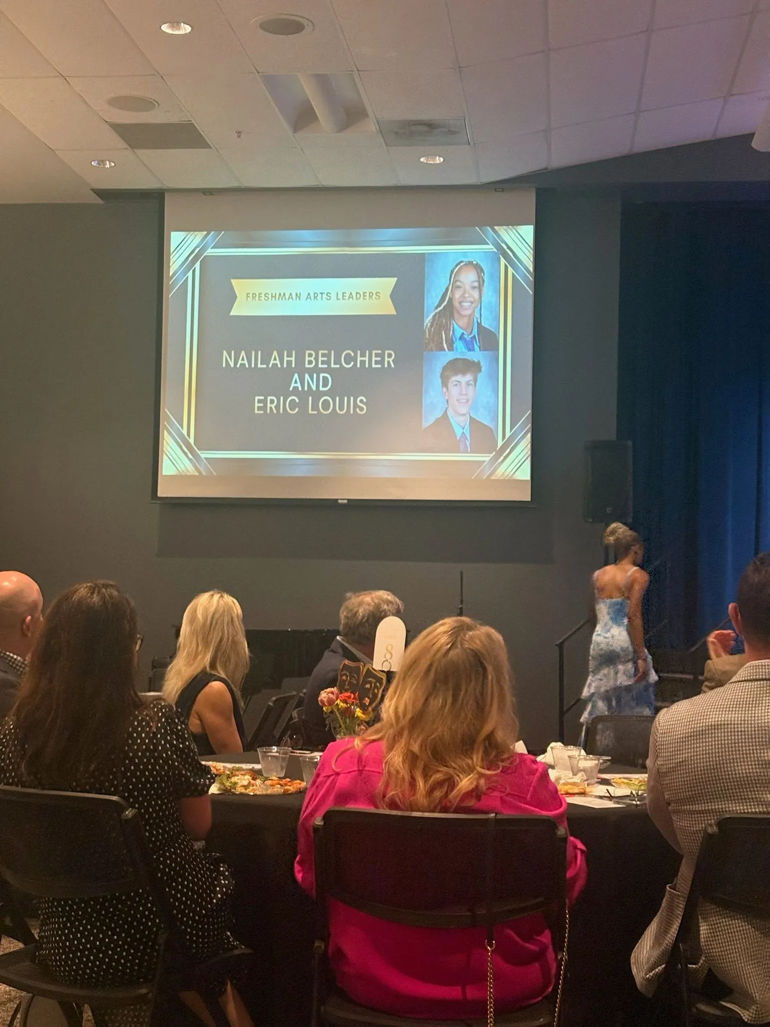 Presentation slide recognizing Nailah Belcher as a Sophomore Arts Leader alongside Eric Louis