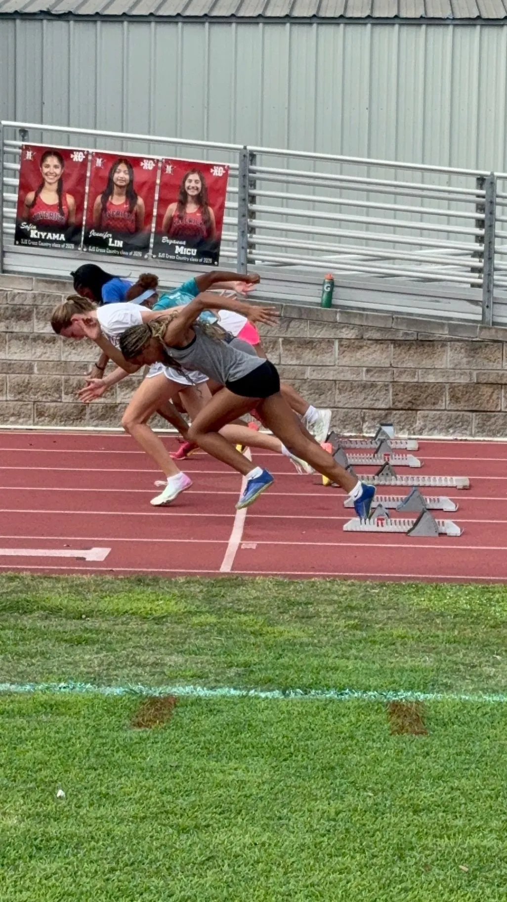 Nailah Belcher exploding out of the starting blocks on an outdoor track